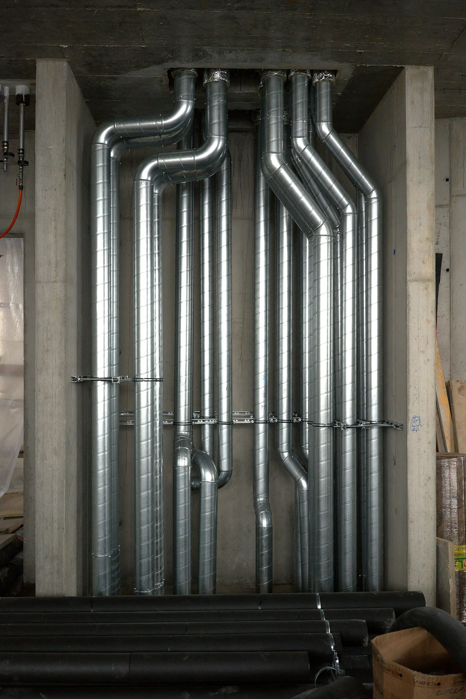 Metal exhaust ductwork running along the ceiling of a commercial building